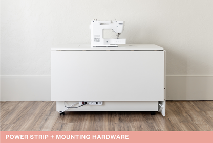 White sewing machine on a white cabinet with a power strip and mounting hardware text overlay. [Deluxe]