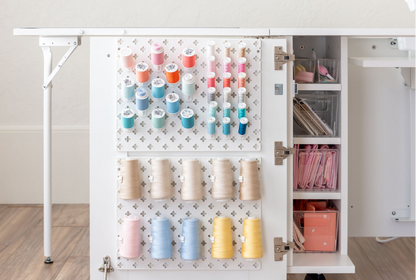 Pegboard with thread spools in a craft room setting [Deluxe]